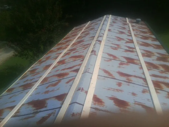 Rusted metal roof panels with new wood purlins before replacement — Storm Damage Roof Repair in Gray by Roofing Brothers